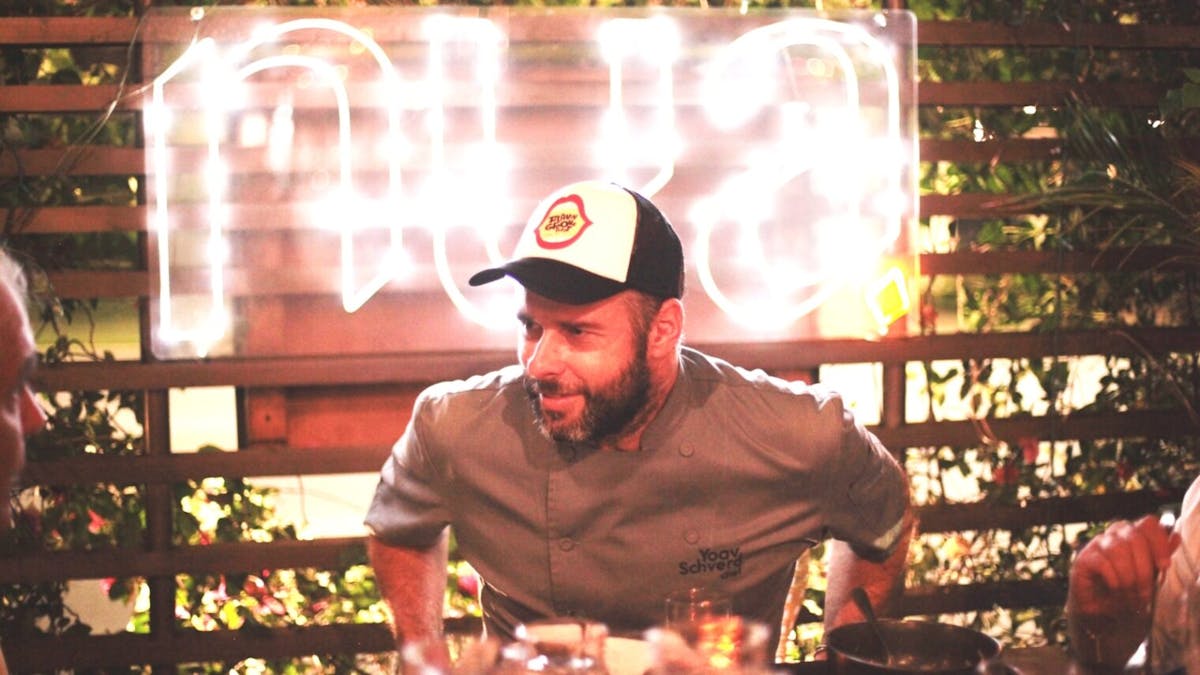a man standing in front of a cake