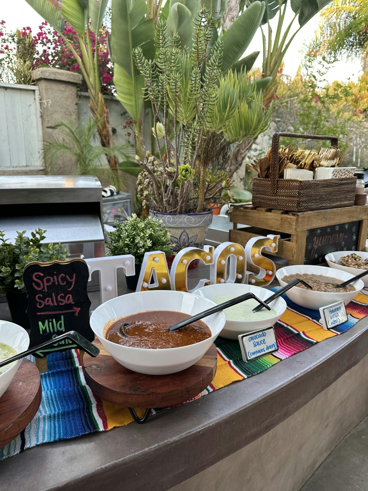 a plate of food on a table next to a palm tree