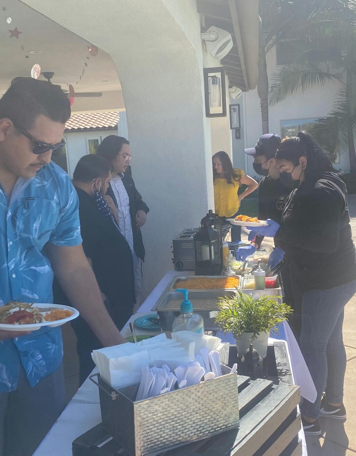 a group of people standing being served food