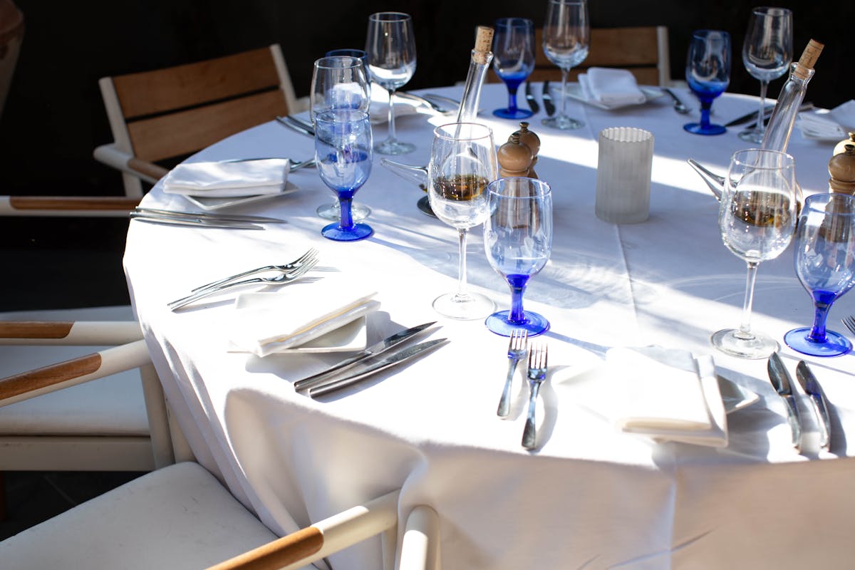 a group of people sitting at a table with wine glasses