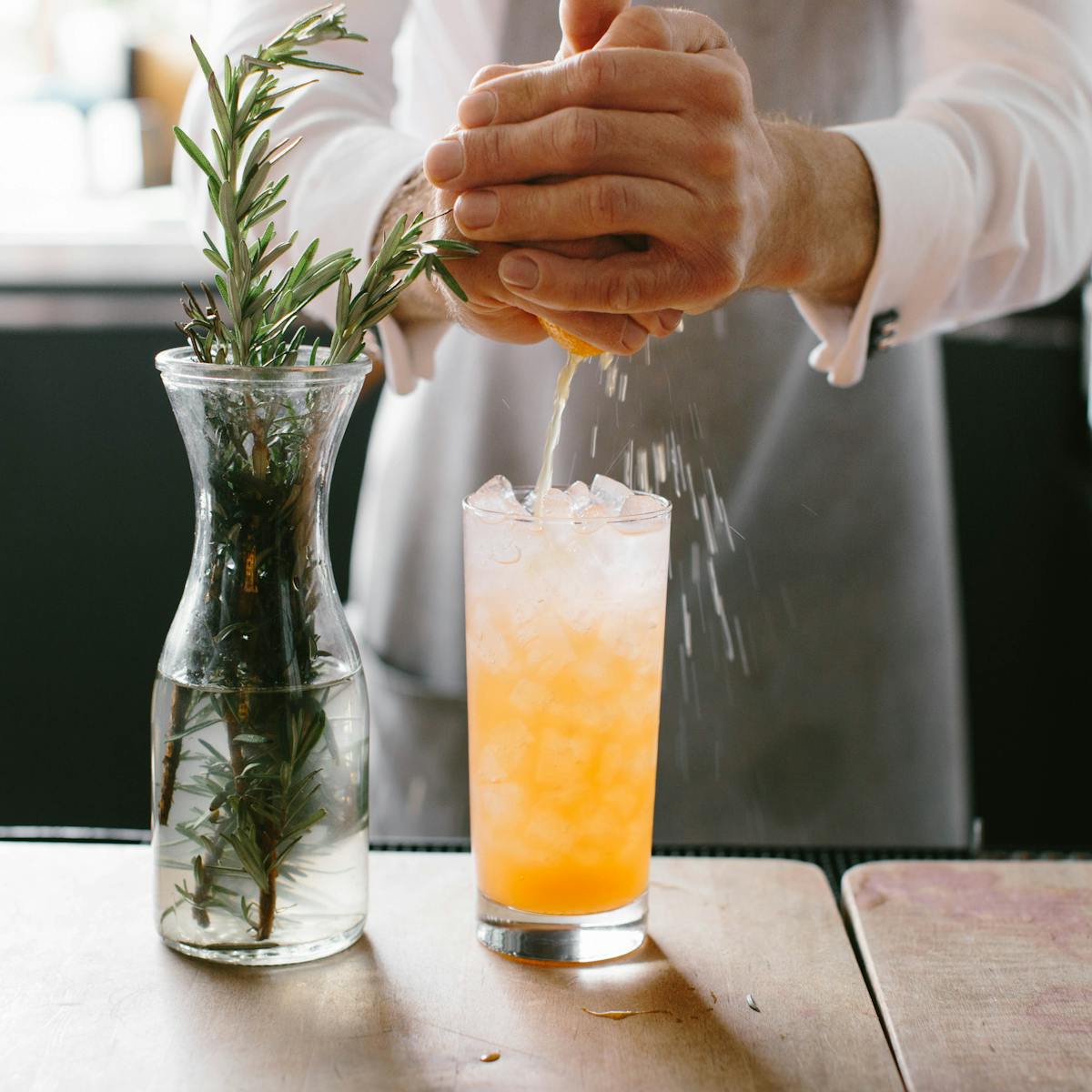 a person holding a glass of orange juice