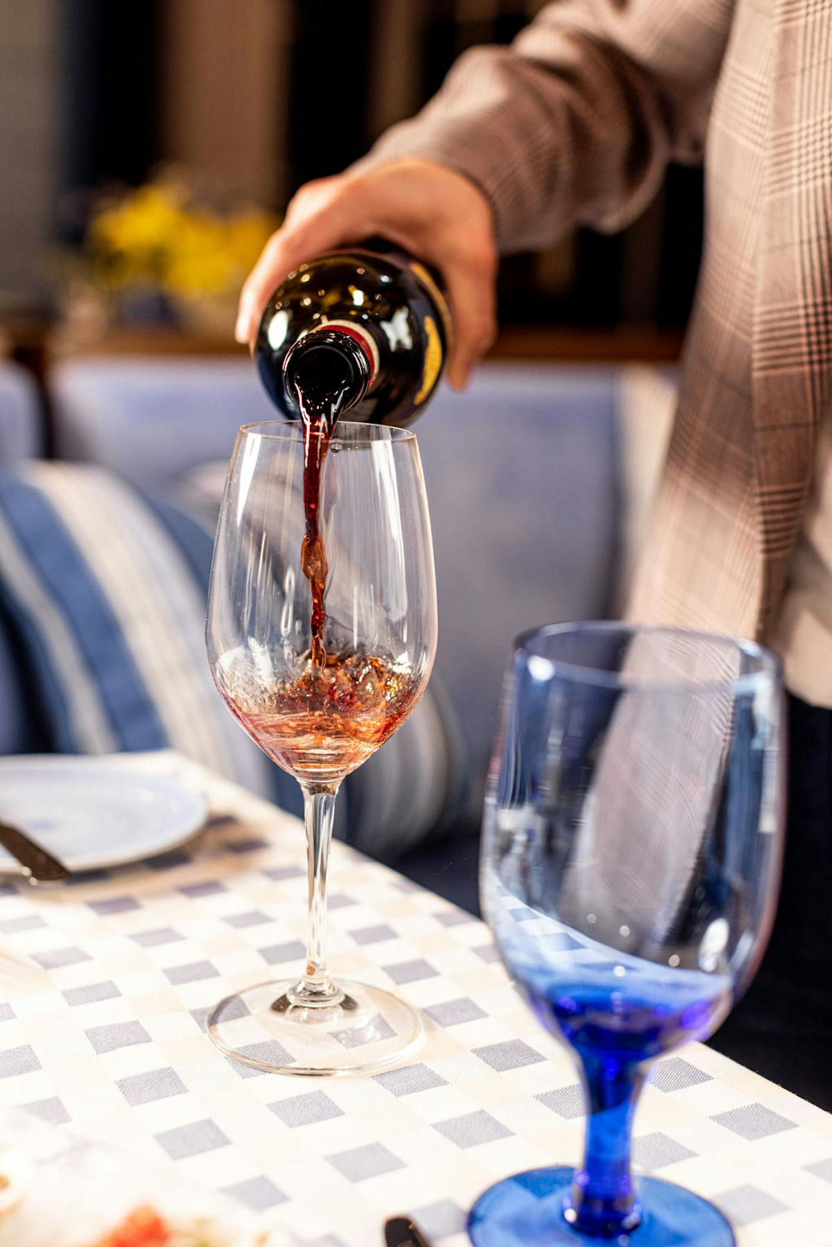 a hand holding a glass of wine