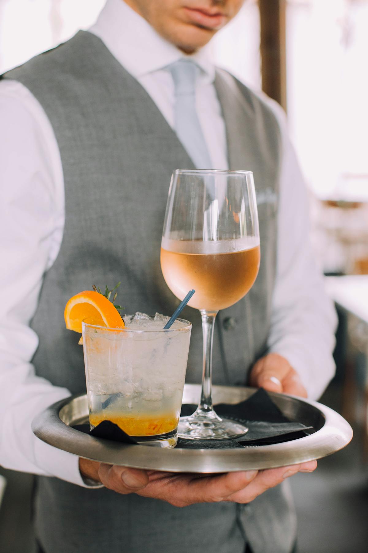 a man sitting at a table with a glass of orange juice