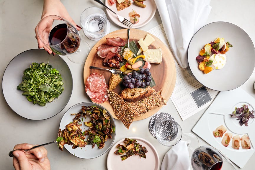 a group of people sitting at a table with a plate of food