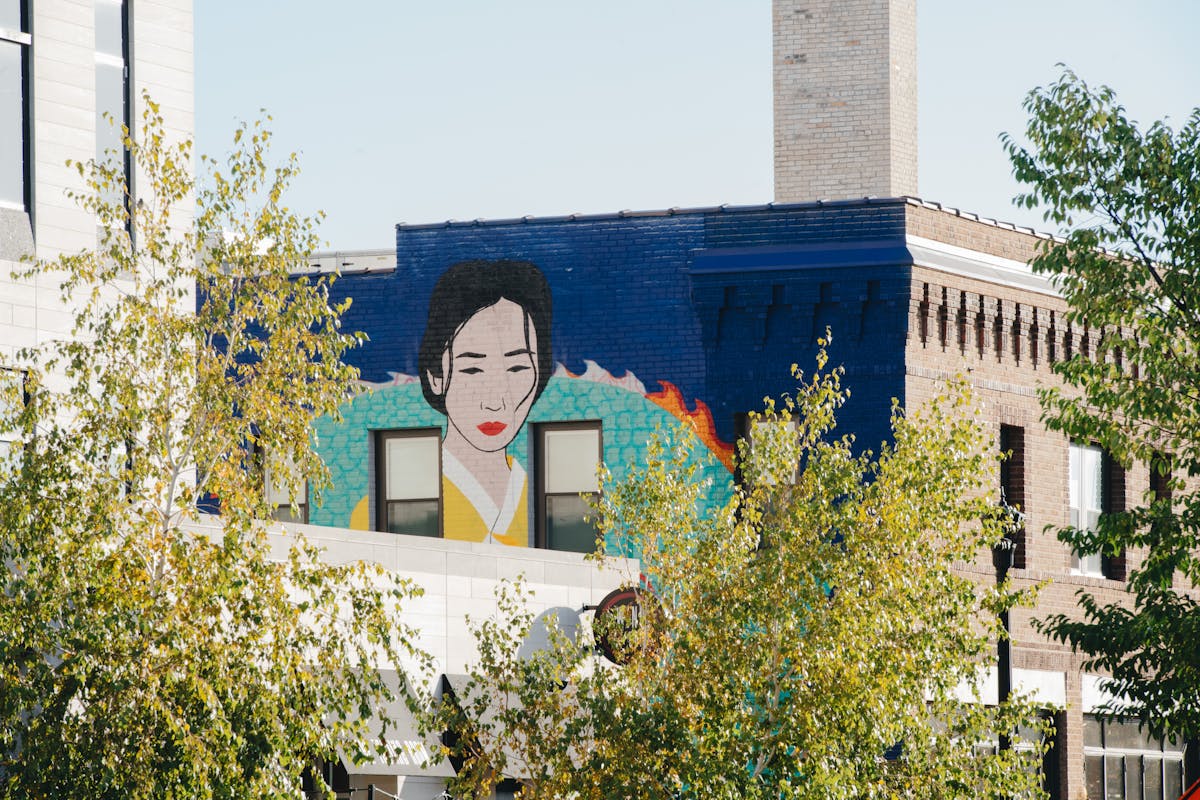 A mural of a woman, dragon, and colorful phoenix