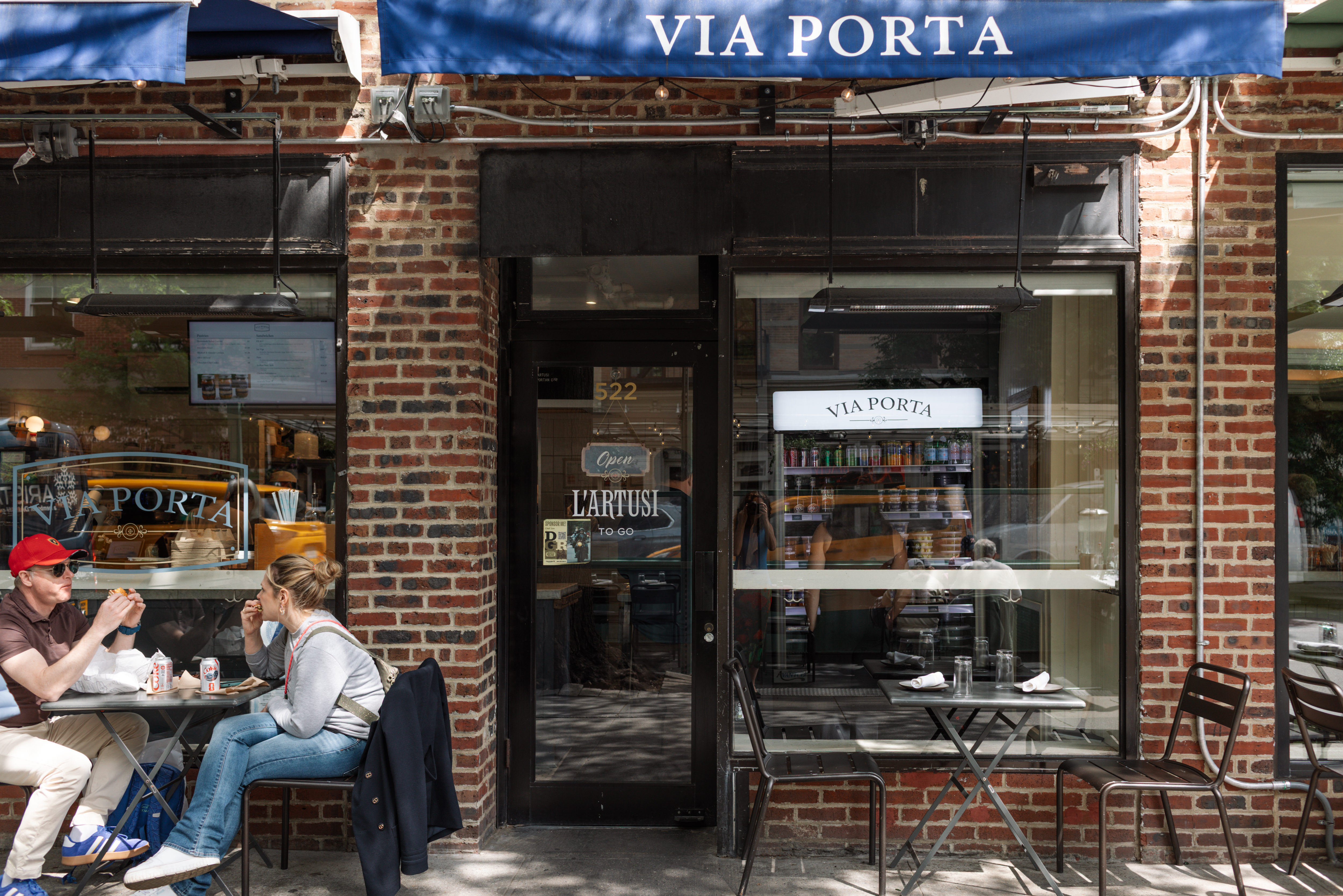 a woman sitting outside a restaurant