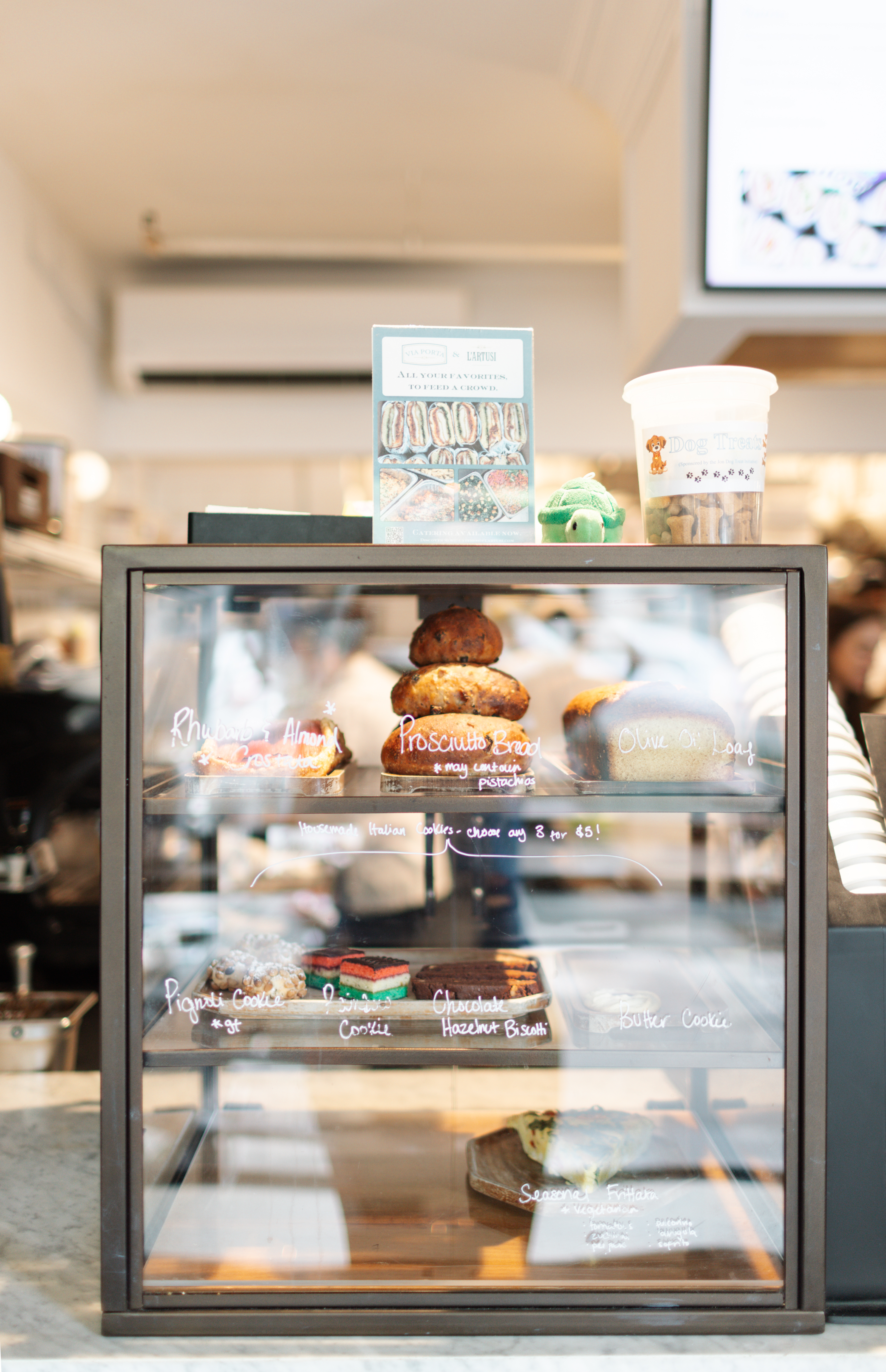 a display case with pastries and coffee