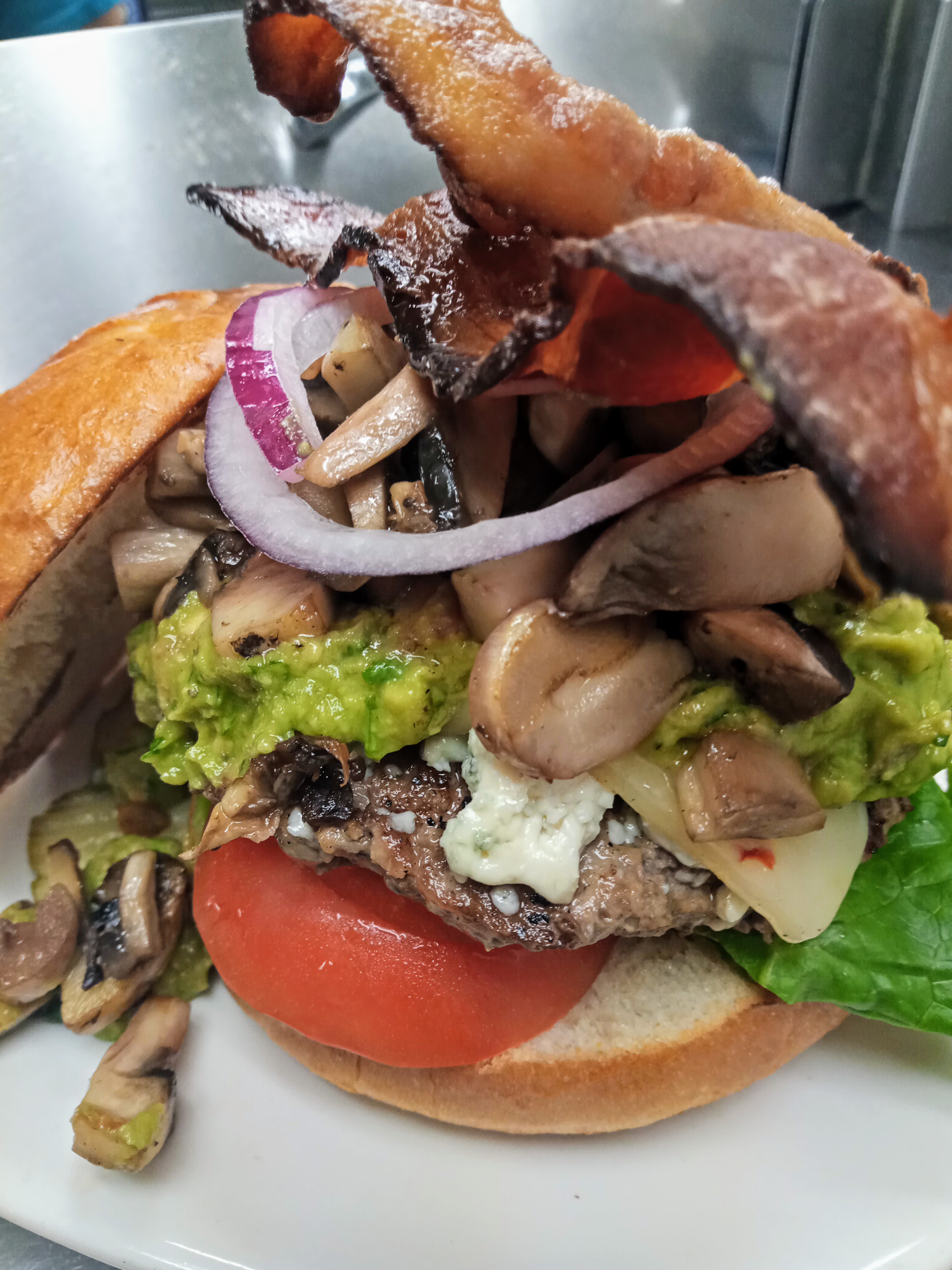 a sandwich with meat and vegetables on a plate