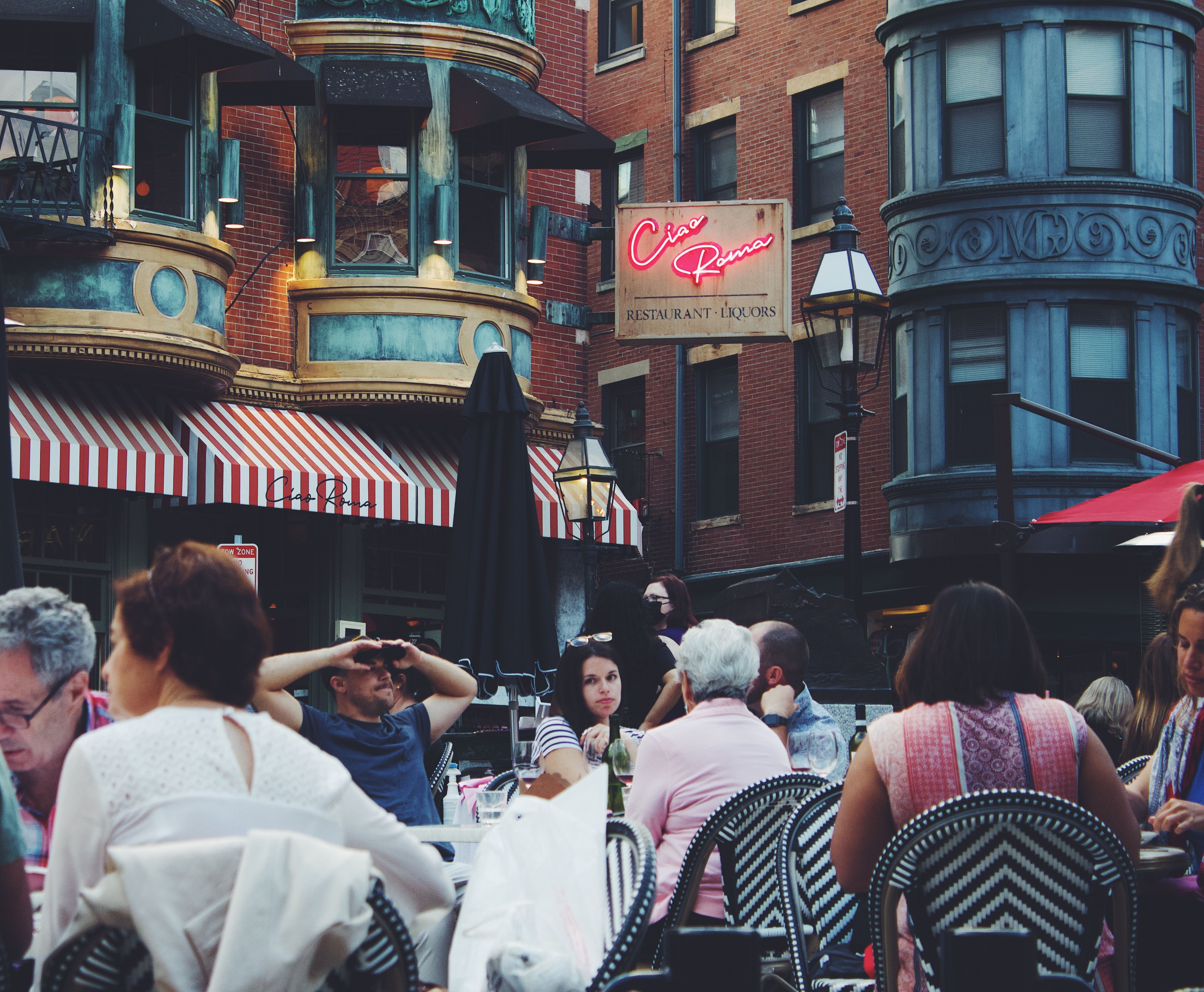 a group of people sitting at a crowded street