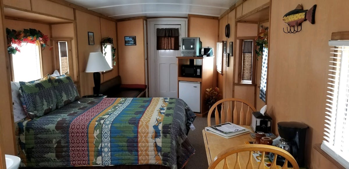 a bedroom with a bed and a chair in a room