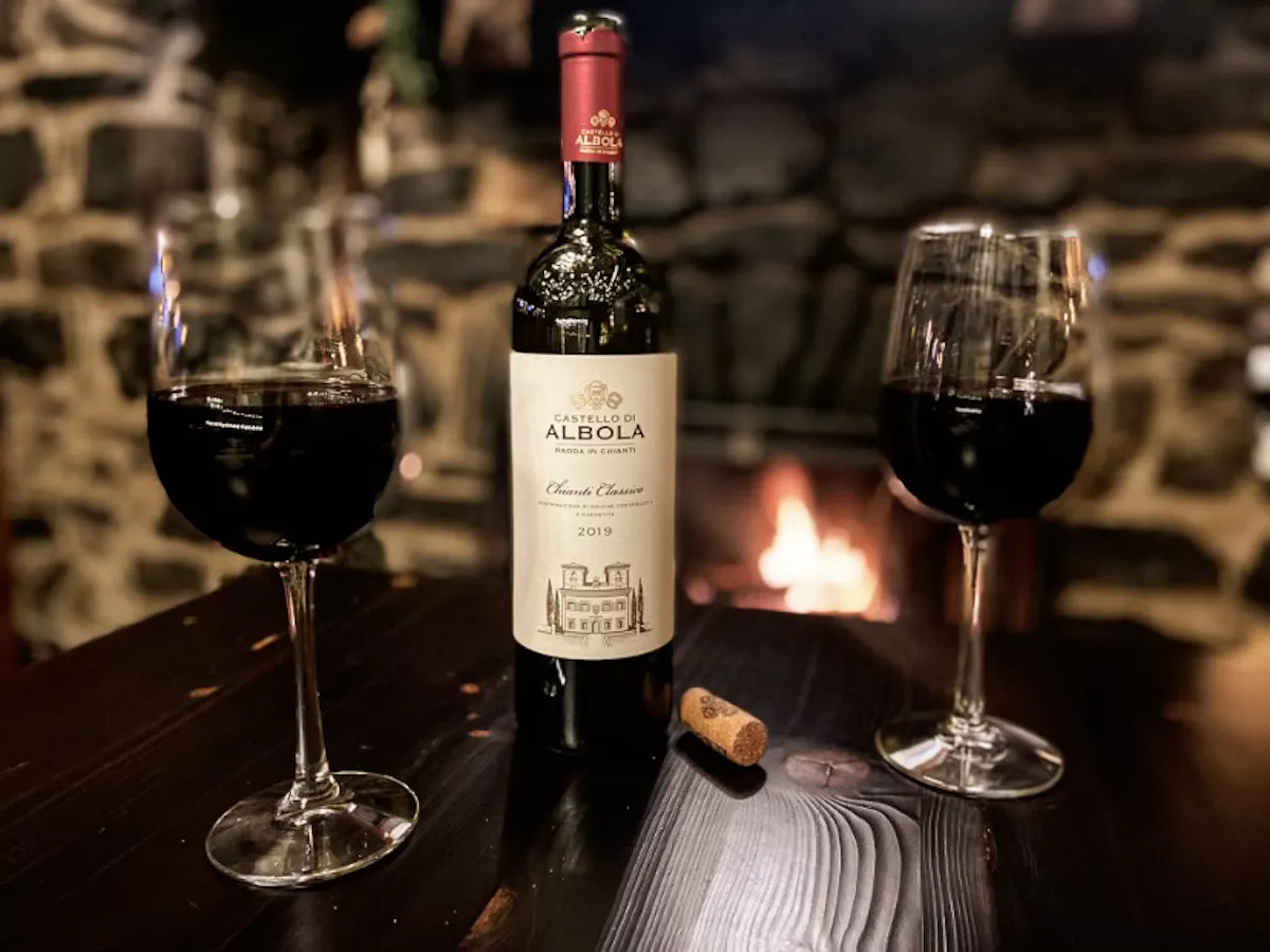 a close up of a bottle and a glass of wine