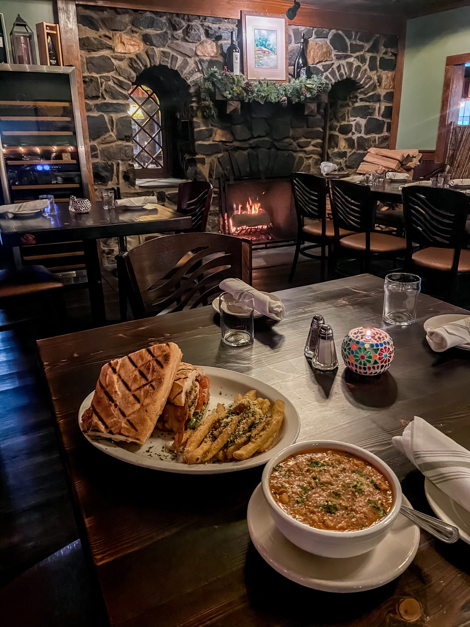 a plate of food on a table next to a fireplace