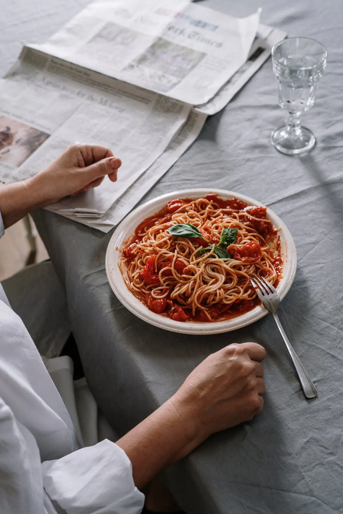a woman sitting at a table with a plate of food