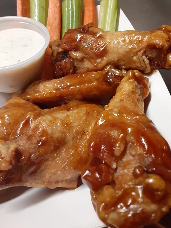 close up of several chicken wings on a plate