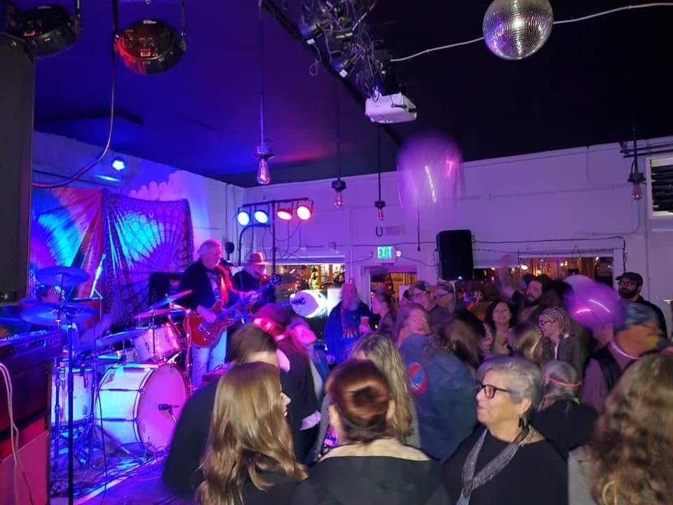 a group of people on a stage in front of a crowd