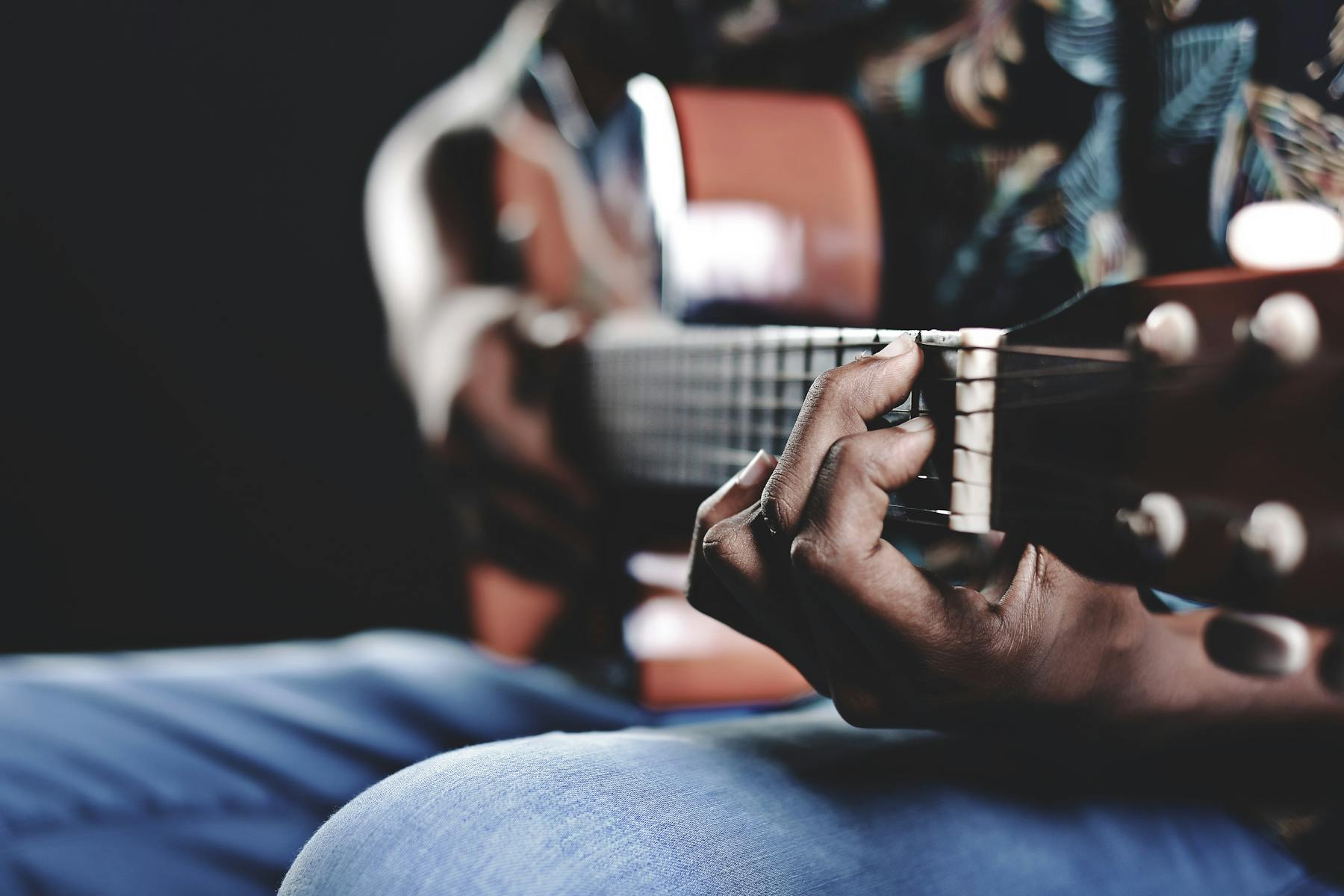 a close up of a person holding a guitar