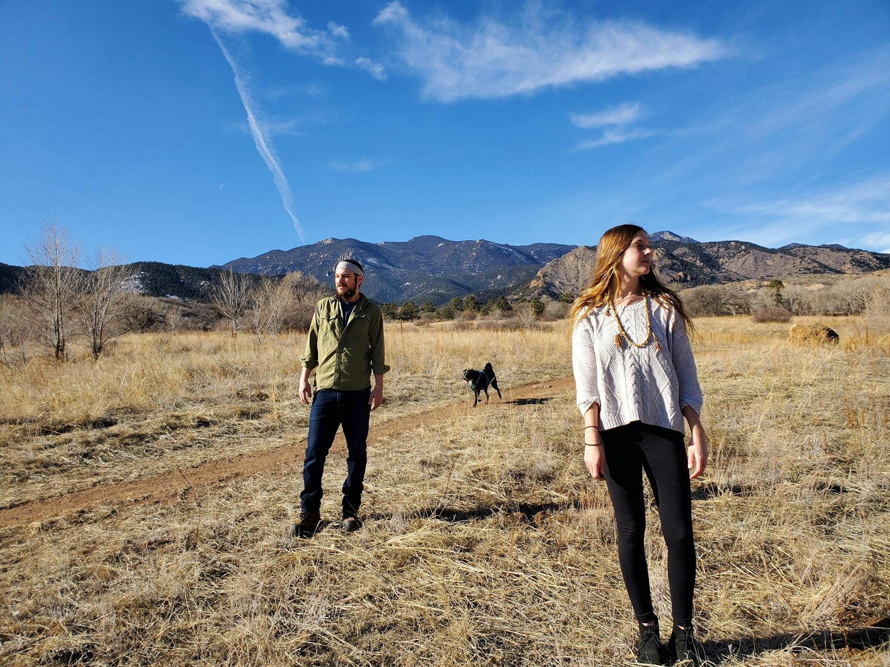 a person standing on a dry grass field
