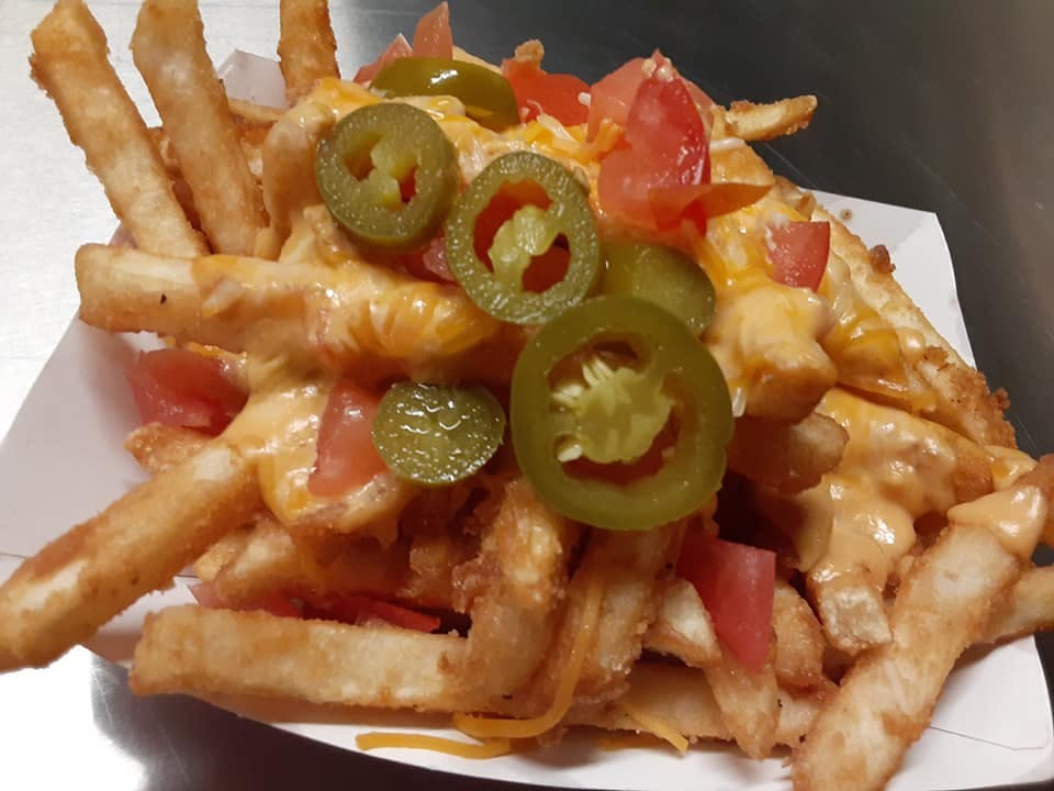 a pile of fries with jalapeño