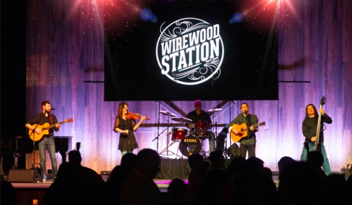 a group of people on a stage in front of a crowd