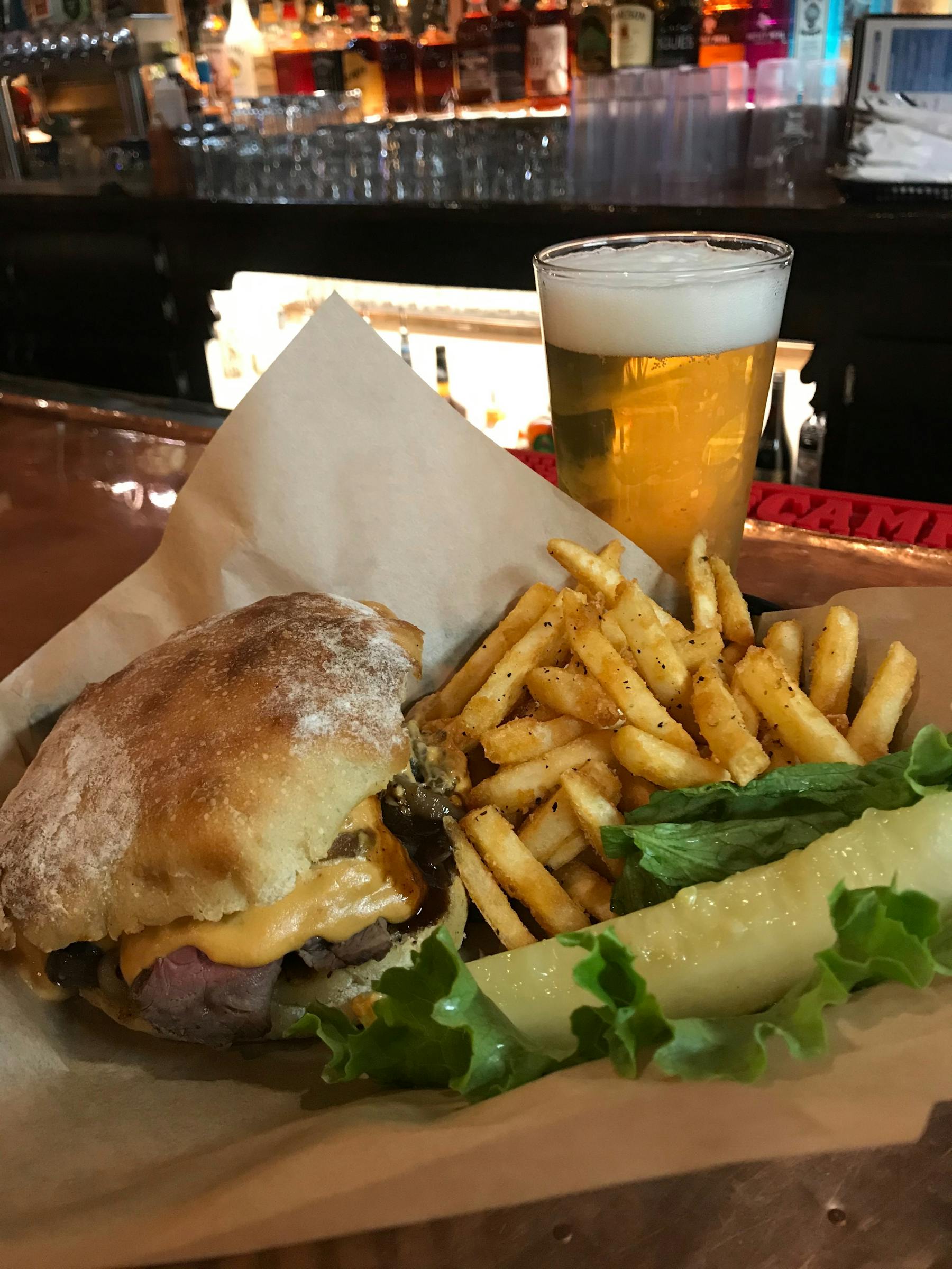 a large sandwich sitting on top of a pile of fries