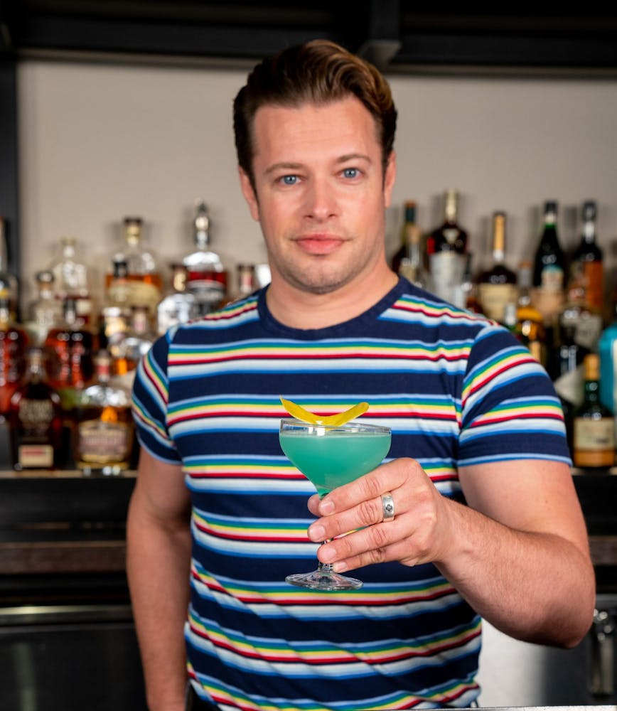 a person in a striped shirt and smiling at the camera