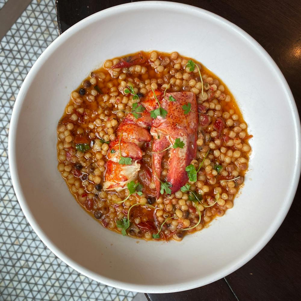 a plate topped with different types of food on a table