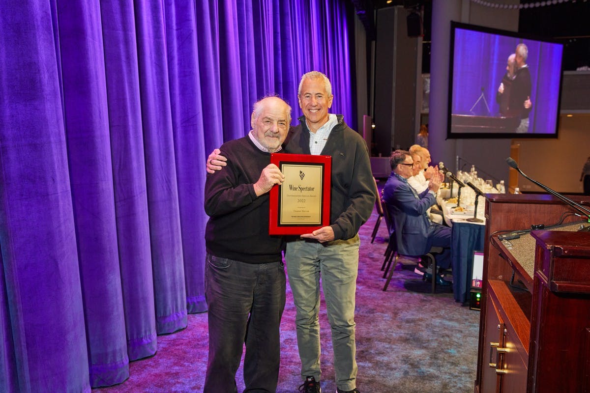 Marvin Shanken, Danny Meyer standing in front of a curtain