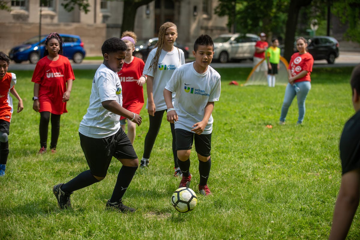 a group of young people playing football on a field