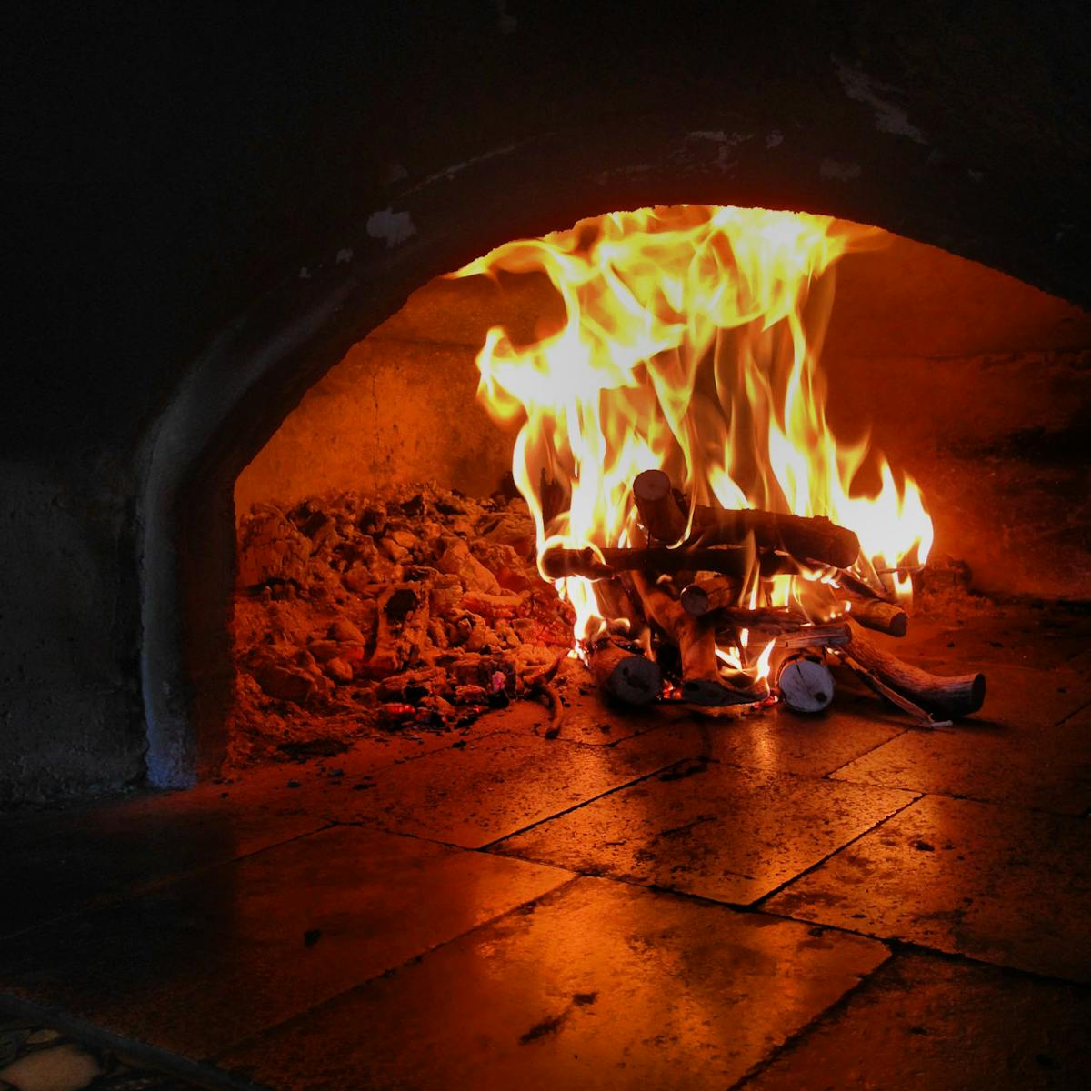 a stove top oven sitting next to a fireplace