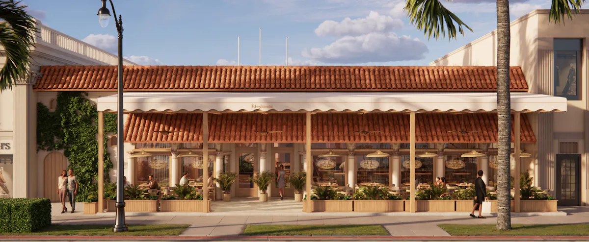 a building with a red roof and a couple of people standing in front of it