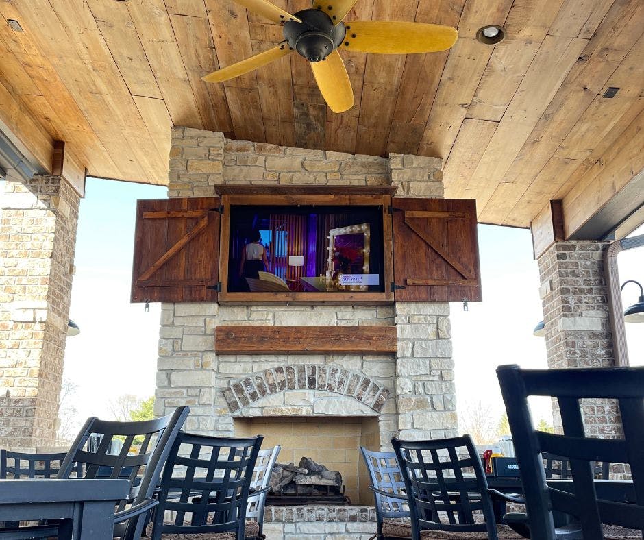 a wooden bench sitting next to a fireplace