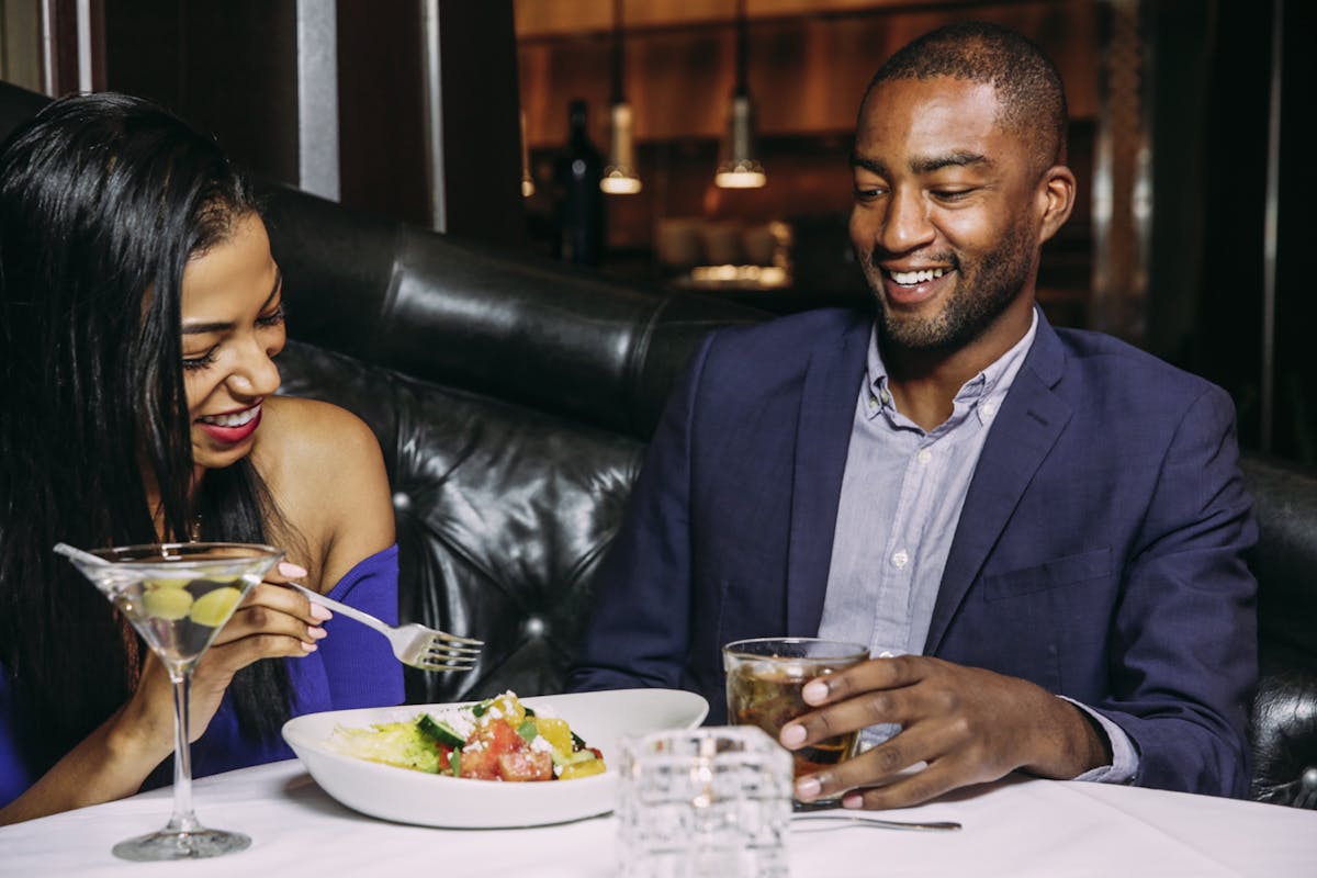 a couple enjoying food on a table