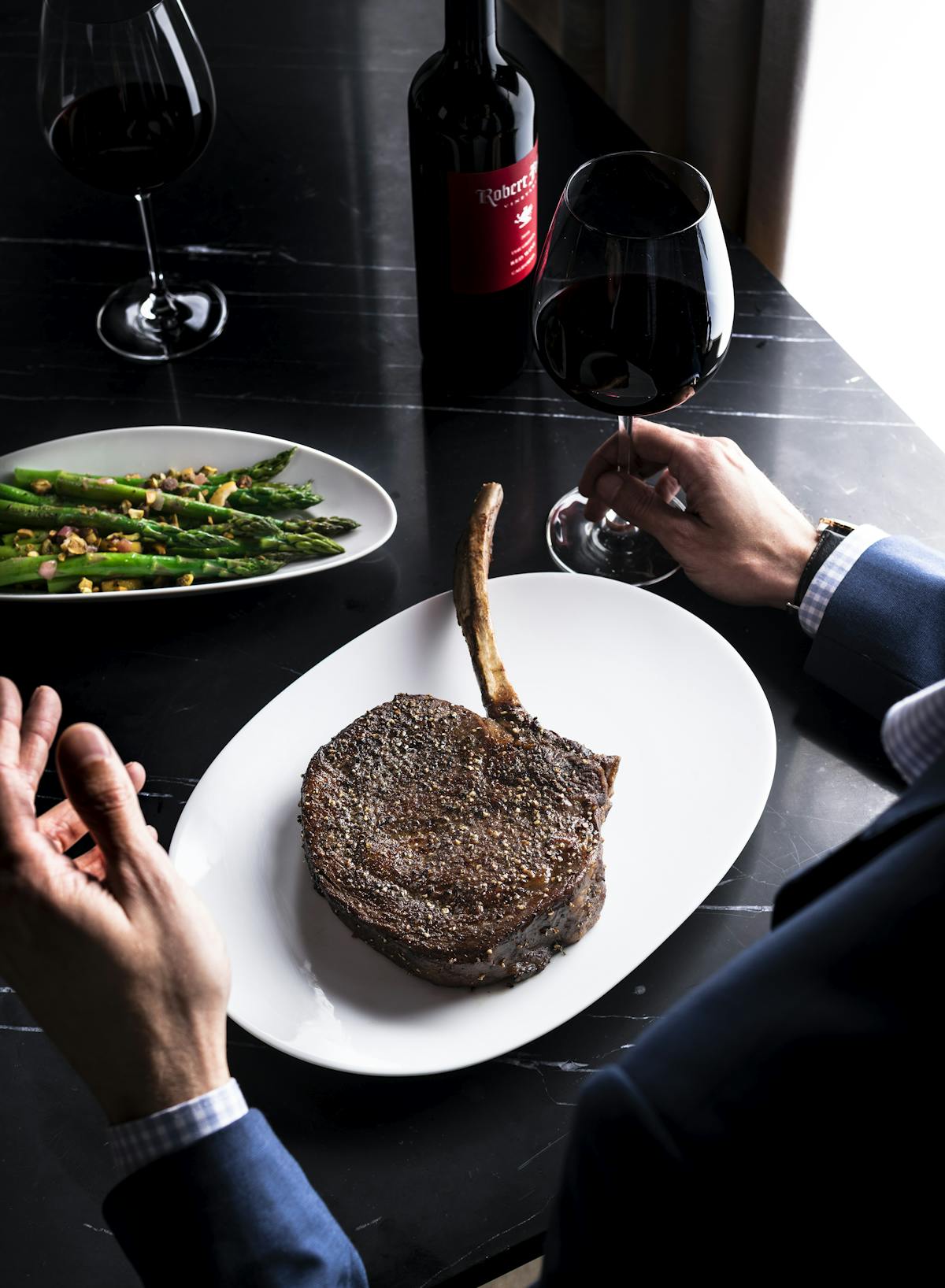 a person sitting at a table with a plate of food