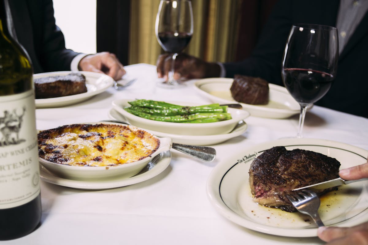 a plate of food and glasses of wine on a table