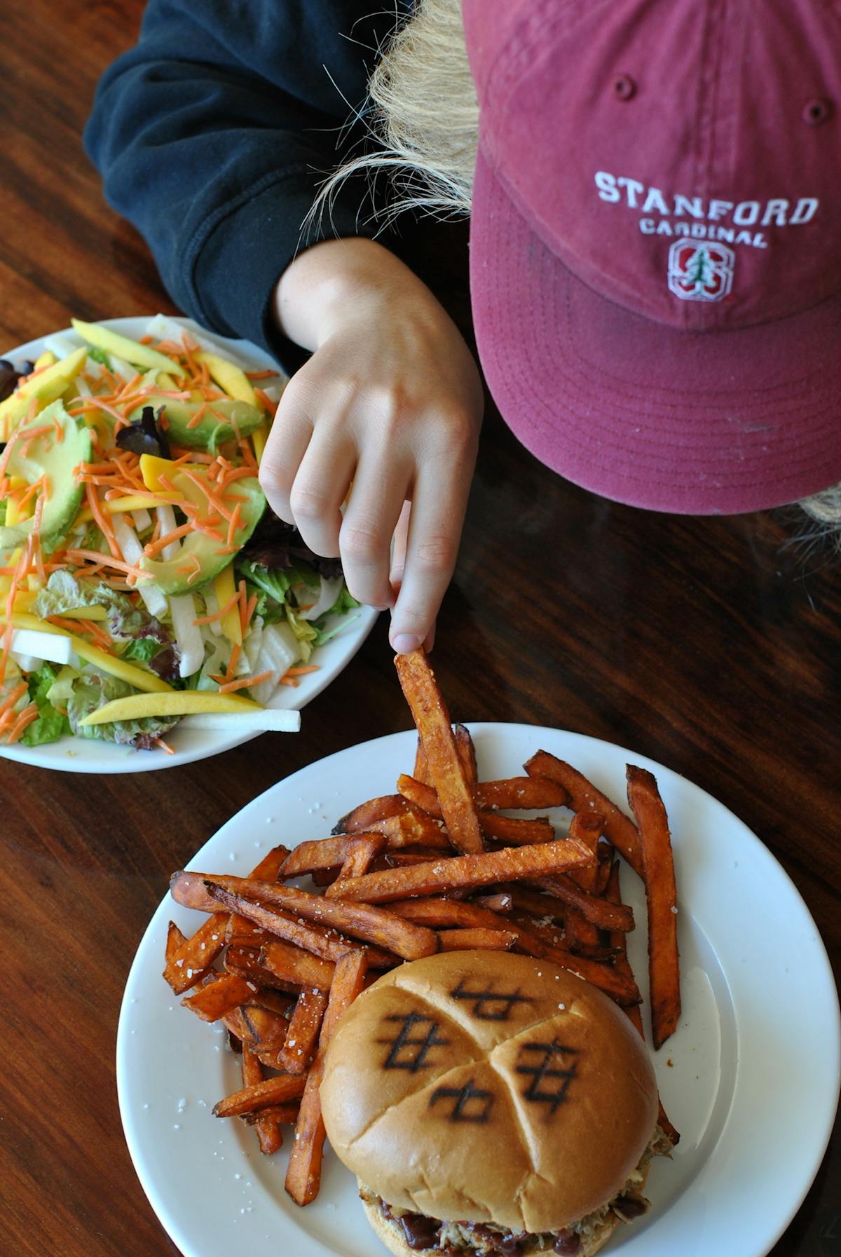 a person sitting at a table with a plate of food