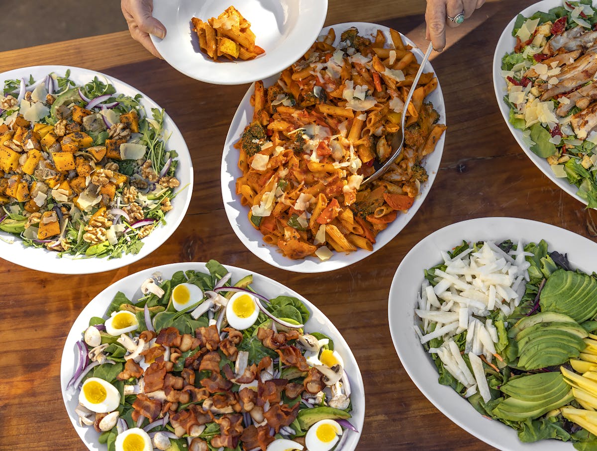 a wooden table topped with different types of food on a plate