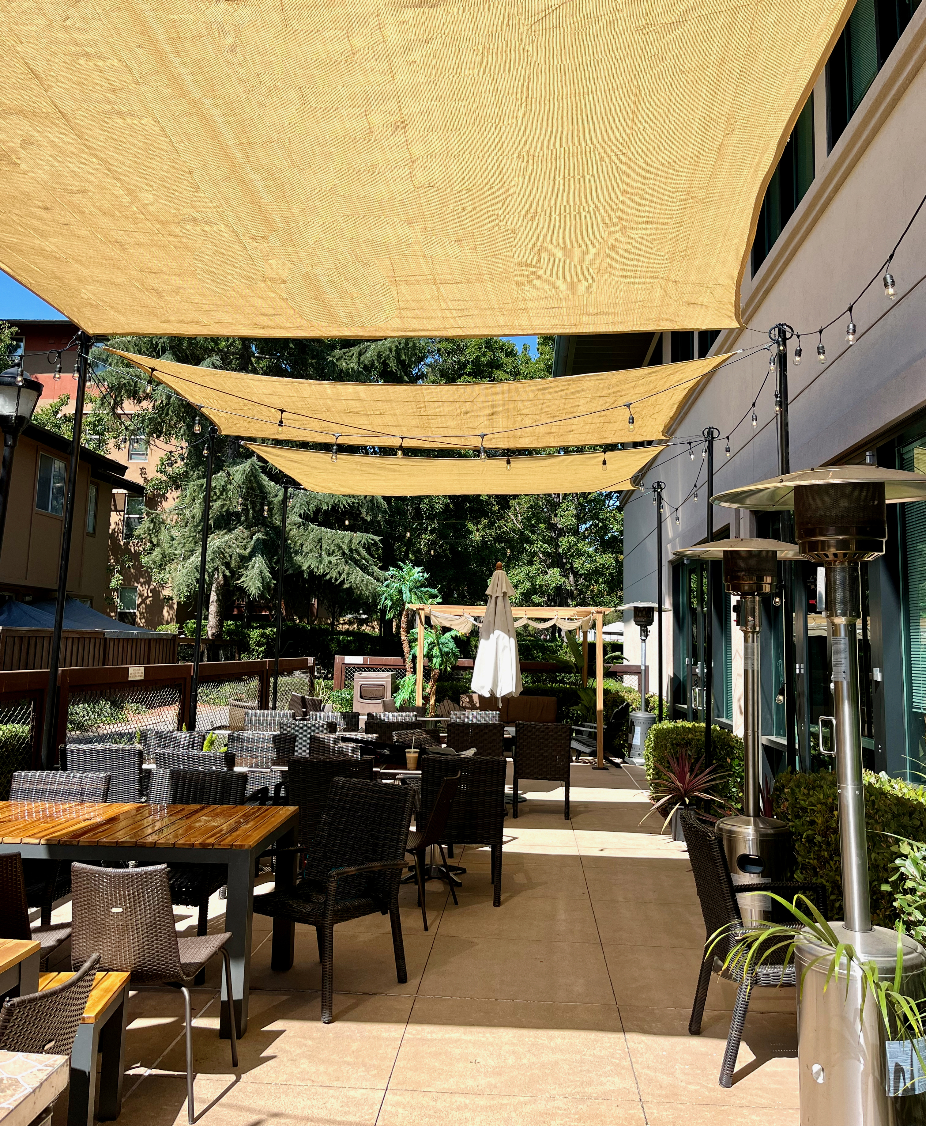 a group of people sitting at a table in front of a building