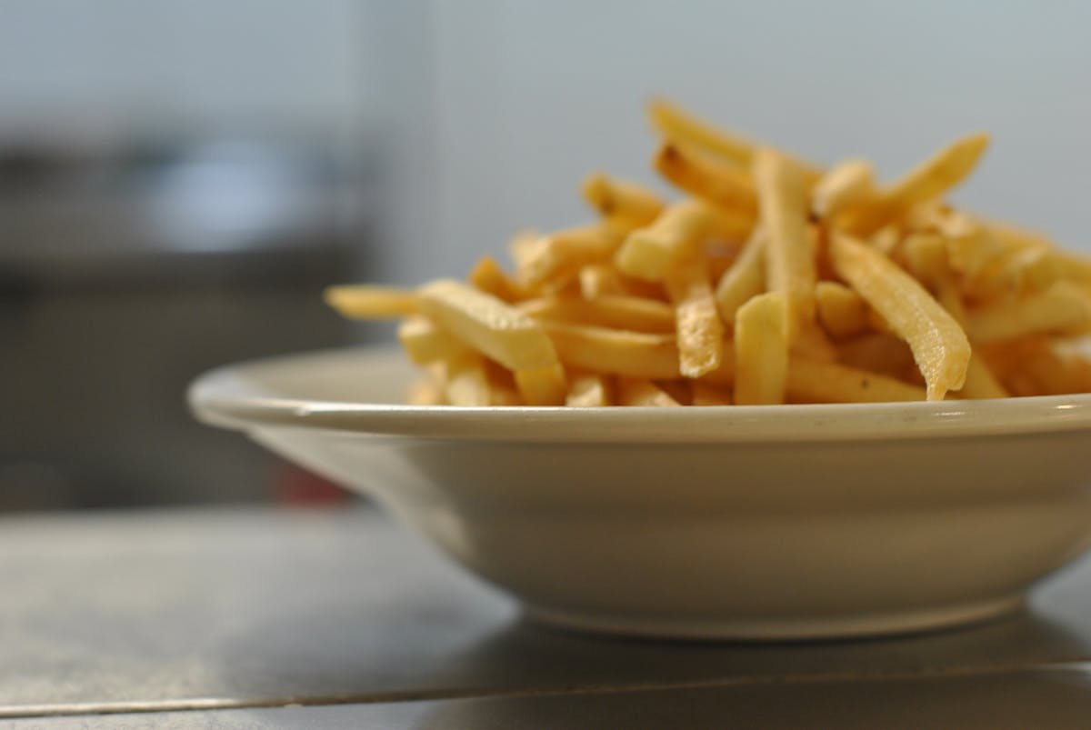 a close up of a bowl of fries