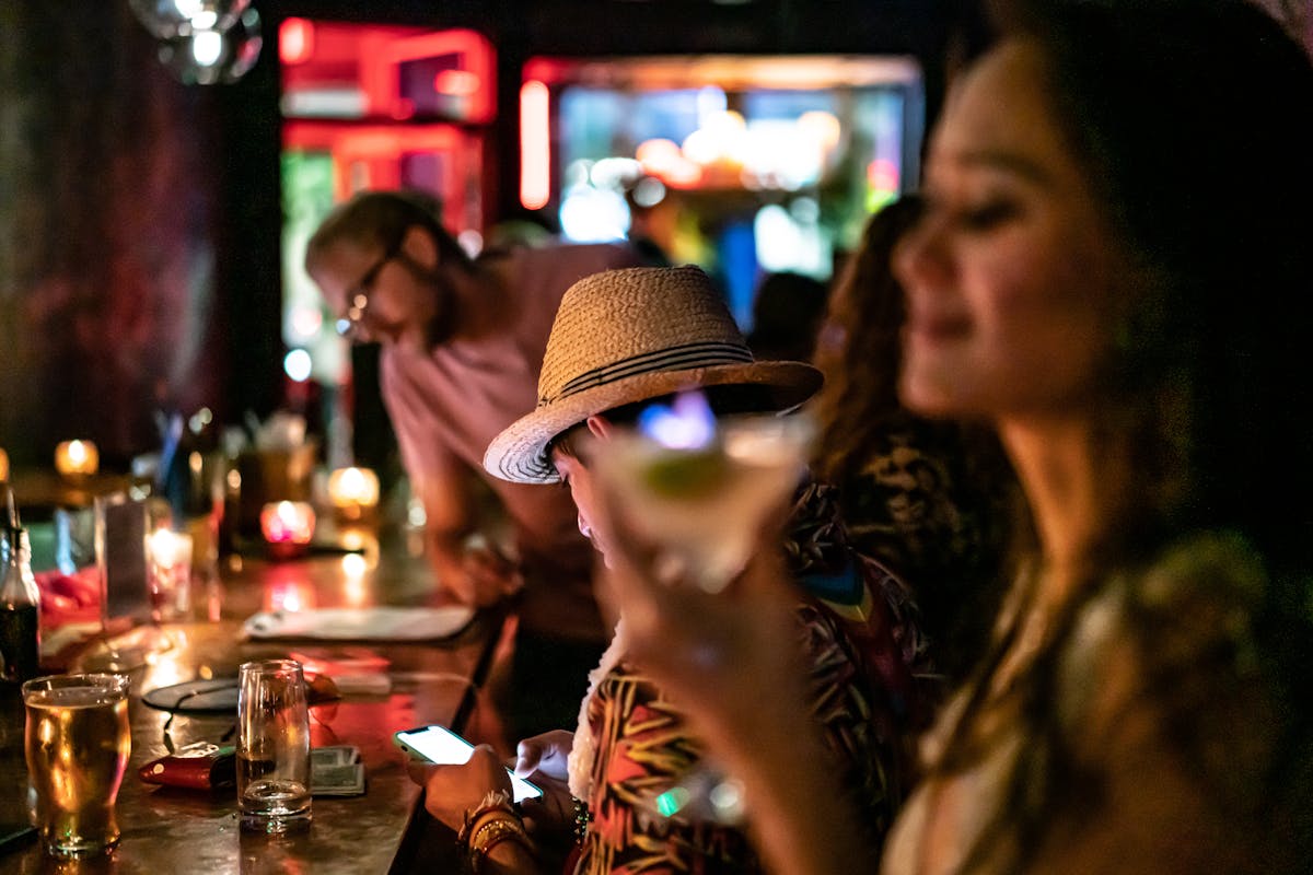 a person sitting at a table with wine glasses