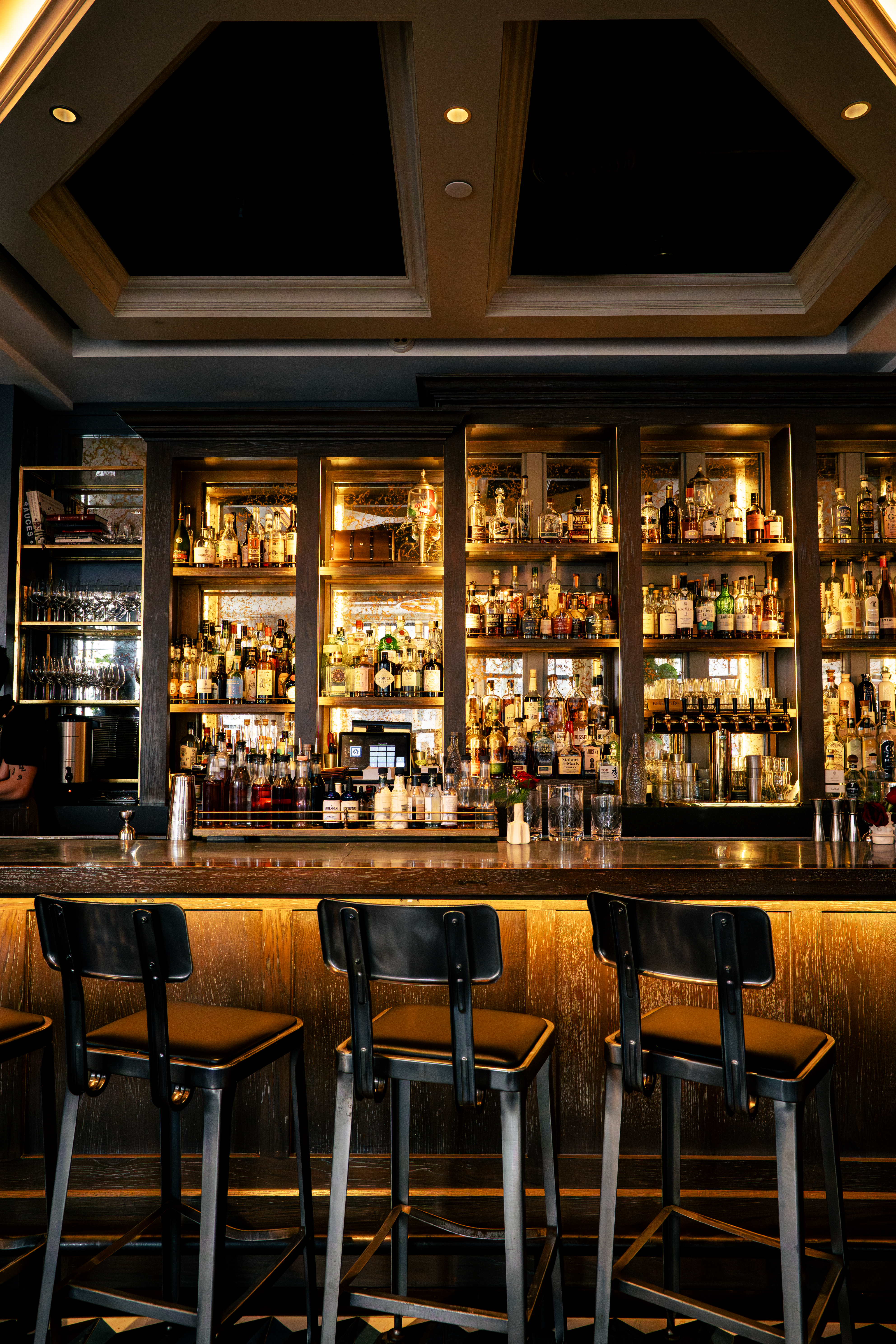 a bar with many bottles and shelves of liquor