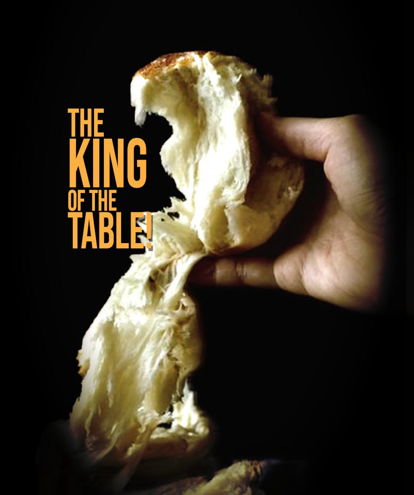 a hand holding a hot dog