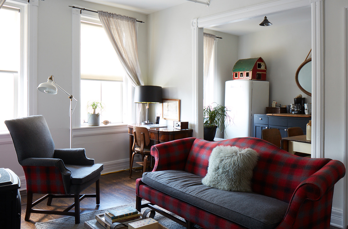 a living room filled with furniture and a large window
