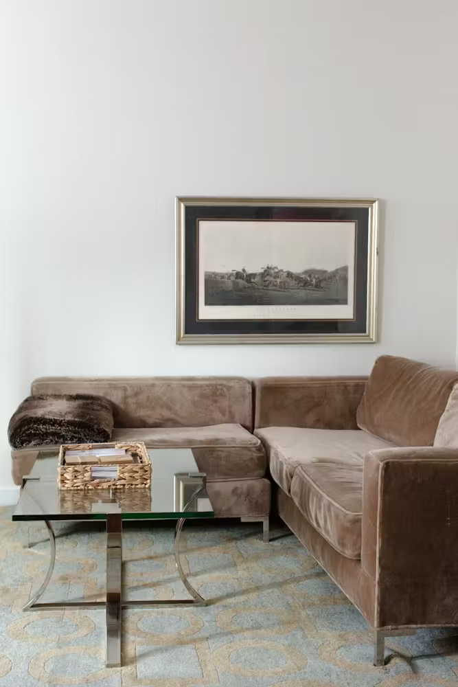 a living room with a bed and chair