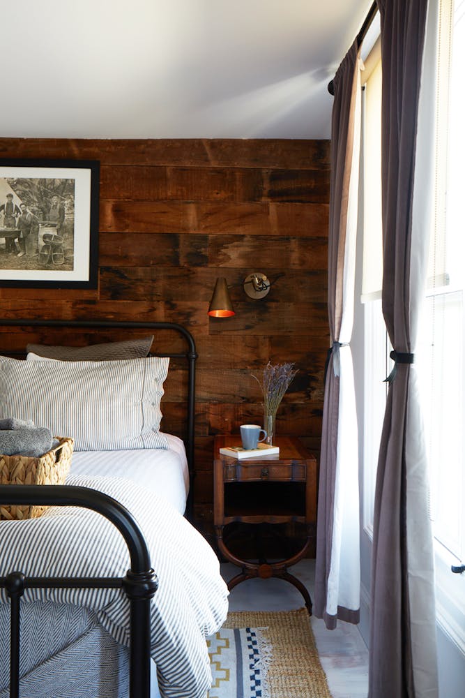 a bedroom with a fireplace and a chair in a room