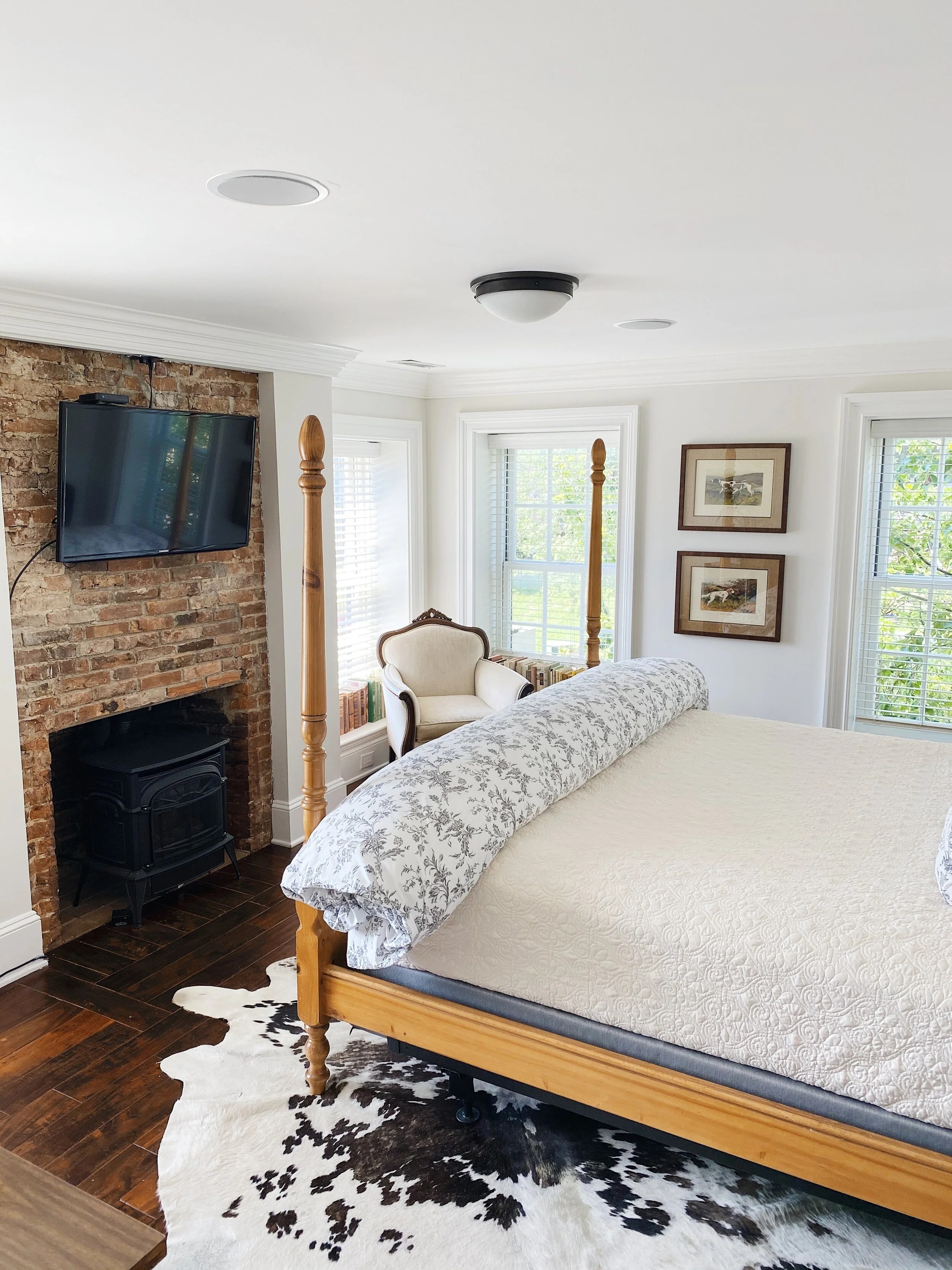 a living room with a bed and a fireplace