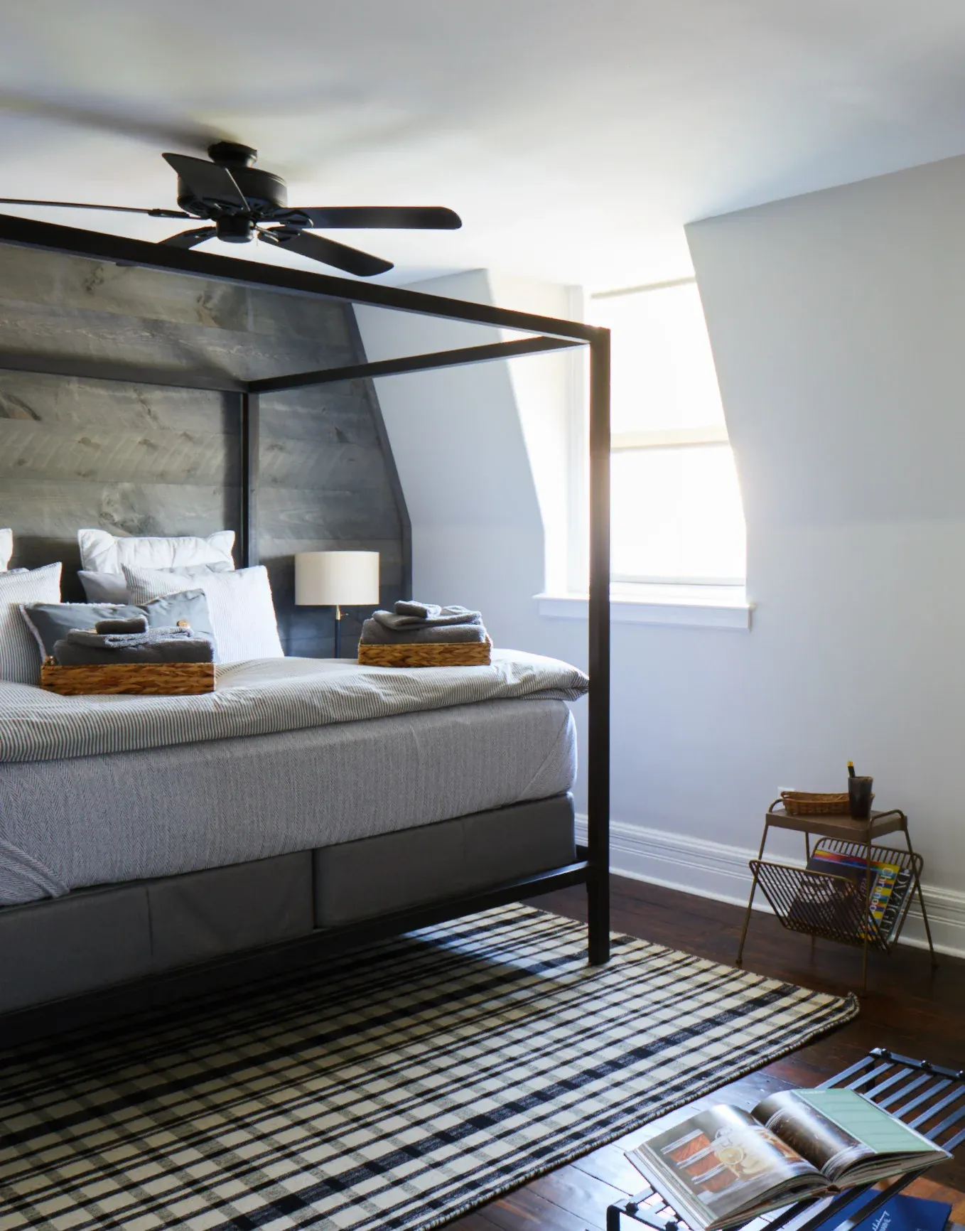 a bedroom with a bed and desk in a room