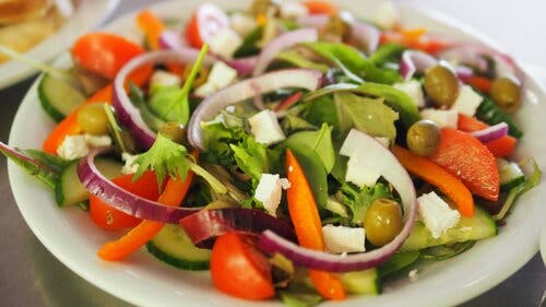 a bowl of salad on a plate