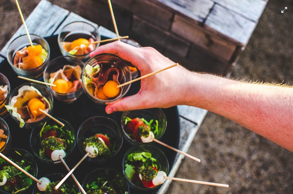 a person holding a bowl of food