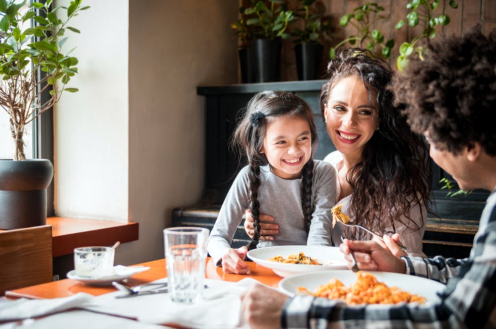 a person sitting at a table with food