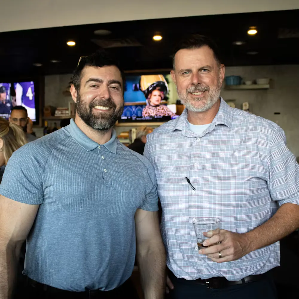 men standing in front of a group of people posing for the camera at gatherings event space in dallas